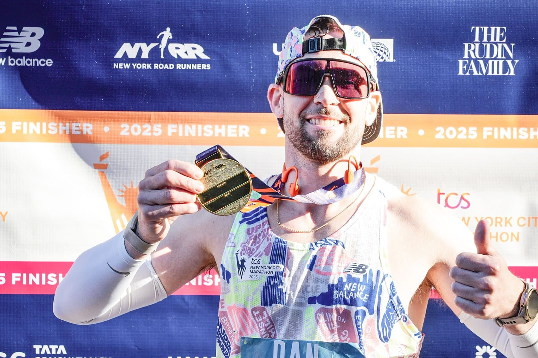 Daniel holding his finisher's medal at the 2025 TCS New York City Marathon